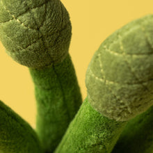 Load image into Gallery viewer, Close-up of green textured fabric with a yellow background Jellycat Amuseables Asaparagus Plush toy