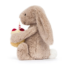 Load image into Gallery viewer, Jellycat Bashful Beige Bunny | Birthday Plush bunny holding a small cake with a candle on a white background
